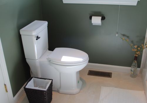 Skirted toilet installed in a bathroom by Denommee Plumbing, HVAC & Electric
